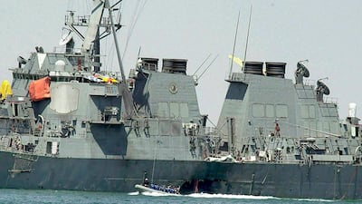 Experts in a speed boat examine the damaged hull of the USS Cole at the Yemeni port of Aden after an Al Qaeda attack that killed 17 sailors in October 2000. Dimitri Messinis / TAP Photo