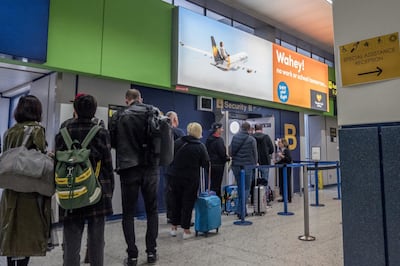 Passengers wait to go through to the Thomas Cook check-in desks at Manchester Airport (Photo by Anthony Devlin/Getty Images)