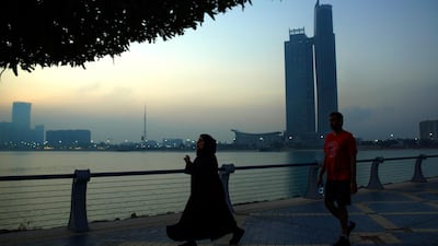 The sun rises on a foggy Wednesday morning at the Corniche. Victor Besa / The National