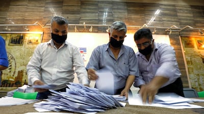 Men count ballots at a polling station during parliamentary election in Damascus, Syria. Reuters