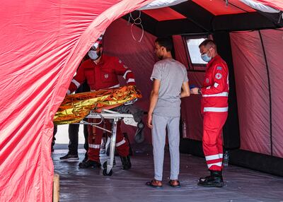 A migrant who survived the sinking receives medical care in Kalamata. Getty Images