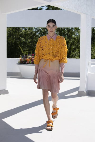 A military camouflage net is rethought into a delicate, laser-cut jacket in marigold as part of the spring / summer 2022 collection by Qasimi. Courtesy Qasimi