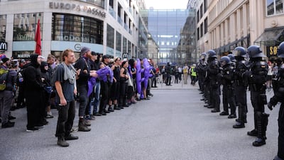 Demonstrators face policemen during a protest. Steffi Loos / AFP Photo