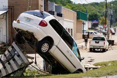A car leans against a utility pole Sunday, Aug. 22, 2021, in Waverly, Tenn. (AP Photo / Mark Humphrey)