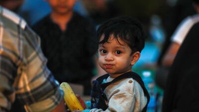 Iftar meals are distributed to visitors at the mosque. Victor Besa / The National