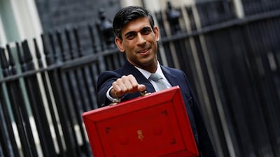 UK finance minister Rishi Sunak holds the budget box outside his office in Downing Street in London last year. Mr Sunak’s tax increase will see corporation tax rise sharply from its current rate of 19 per cent. Reuters