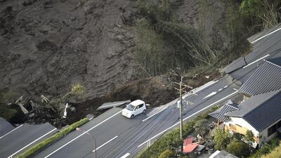 A car sits on a road collapsed by an earthquake in Minamiaso, Kumamoto prefecture, southern Japan. A powerful earthquake struck southern Japan early Saturday, barely 24 hours after a smaller quake hit the same region. Muneyuki Tomari / Kyodo News via AP