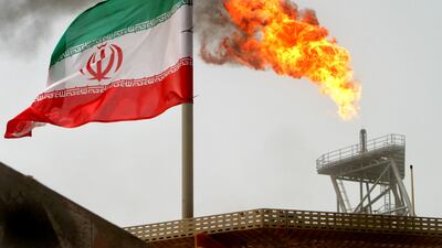 A gas flare in the Soroush oil field alongside an Iranian flag. Reuters