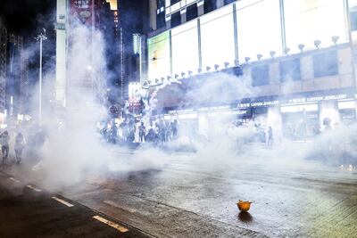Demonstrators stand in a cloud of tear gas on Hennessy Road during a protest in the Causeway Bay district of Hong Kong, China. Bloomberg