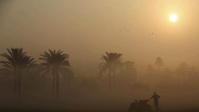 A martial looks at the early morning fog which delayed the first round of Dubai Ladies Masters golf tournament in Dubai. Kamran Jebreili / AP Photo