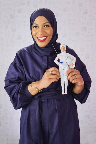 US Olympic fencer Ibtihaj Muhammad holding the first hijab-wearing Barbie, which was based on her. Photo: Mattel