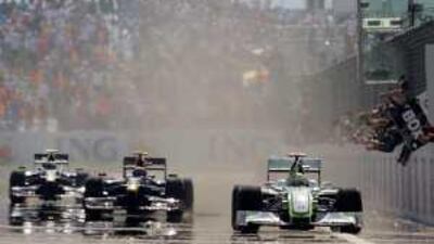 Jenson Button punches the air in delight as his Brawn GP mechanics celebrate after the Briton won yesterday's Turkish Grand Prix. He finished ahead of Mark Webber's Red Bull. Button now leads the championship by 26 points from his teammate Rubens Barrichello, who failed to finish the race.