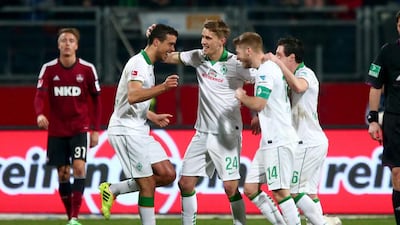 Bremen's Franco Di Santo, left, celebrates his goal with Nils Petersen, centre, Aaron Hunt, second from right, and Zlatko Junuzovic during their match against Nuremberg. Hunt was given accolades after the match for refusing a penalty kick. Bremen went on to win 2-0. Daniel Karmann / EPA