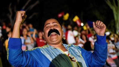 Supporters of the Venezuelan President Nicolas Maduro celebrate after the National Electoral Council announced the results of the voting on election day in Venezuela, in Caracas. Federico Parra / AFP