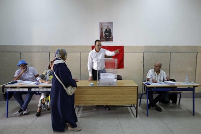 An election official directs a voter at a polling station inside a school in the Hassan neighborhood of Rabat. AFP