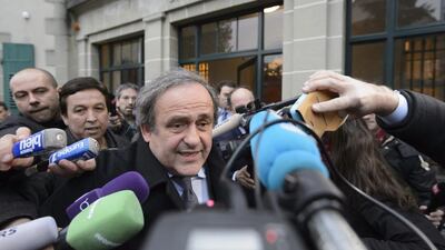 Uefa president Michel Platini of France is surrounded by media after a hearing at the international Court of Arbitration for Sport, CAS, in Lausanne, Switzerland. Sepp Blatter and Michel Platini have been banned for 8 years, the FIFA ethics committee said Monday, Dec. 21, 2015. Laurent Gillieron/Keystone via AP, file
