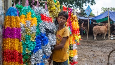 A vendor sells garlands for sacrificial animals near a livestock market in Dhaka, Bangladesh. EPA