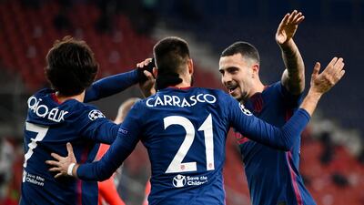 Atletico's Yannick Carrasco celebrates with Joao Felix, left, and Mario Hermoso after scoring their second goal against Salzburg. AP