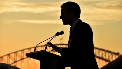 The silhouette of French president Emmanuel Macron as he speaks during a defence strategic partnership event on board the Australian aircraft carrier HMAS Canberra in Sydney. Peter Parks / EPA