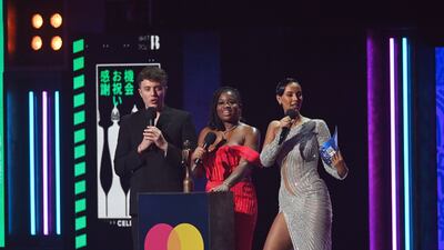 From left, Roman Kemp, Clara Amfo and Maya Jama present the award for the Best International Group. EPA
