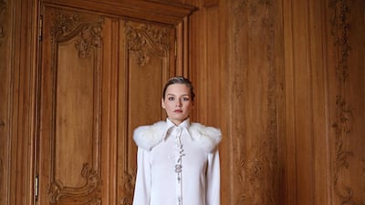 A crepe satin dress with embroidery and fur trim