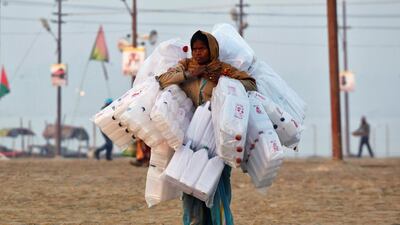 A woman selling plastic containers looks for customers on the banks of the River Ganges on the occasion of Paush Purnima or full moon day, on a cold winter morning during the annual religious festival of Magh Mela, in Allahabad, India. Jitendra Prakash / Reuters