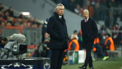 Carlo Ancelotti, left, was full of support for Arsene Wenger, right, after Bayern Munich thrashed Arsenal on Wednesday night. Odd Andersen / AFP