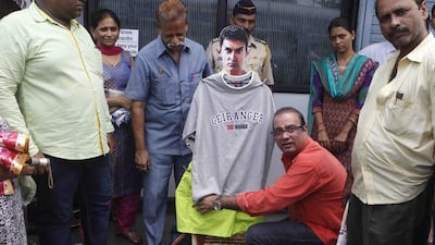 The politician Krishna Hegde “clothed” a cut-out of Aamir Khan that promotes his forthcoming film PK in Mumbai. IANS