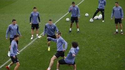 Real Madrid’s Gareth Bale, bottom second right, plays for the ball with teammate Marcelo, bottom right, during training. Francisco Seco / AP Photo