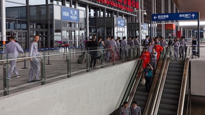 People leave the station in Zhuhai. EPA