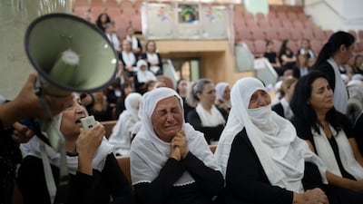 Members of the Druze minority attend a memorial ceremony on Monday for the youths killed in the rocket strike on a football pitch in Majdal Shams. AP