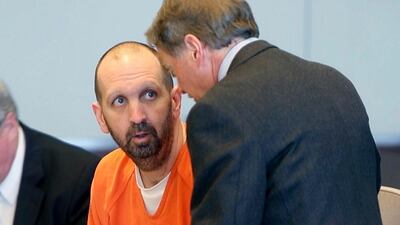 Craig Hicks, center, charged with the murder of three Muslim students in Chapel Hill, North Carolina, listens to attorney Steve Freedman as he makes an appearance in a Durham County courtroom. AP