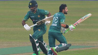 Pakistan's Mohammad Rizwan (R) and Fakhar Zaman run between the wickets during the second Twenty20 international cricket match between Bangladesh and Pakistan at the Sher-e-Bangla National Cricket Stadium in Dhaka on November 20, 2021. (Photo by Munir Uz zaman / AFP)