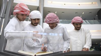 Al Ittihad High School students, (top, from left) Ammar Al Shehli, Aisa Al Romathi, Rashid Al Mazrouei and Mohammed Al Marzooqi, check out the artefacts as they tour the Golden Age of Arab Science exhibition at Paris-Sorbonne University Abu Dhabi. The exhibition highlights the evolution of science in the golden age of the Arab and Islamic civilisation and celebrates the outstanding contributions made by Arab and Islamic pioneers. Silvia Razgova / The National