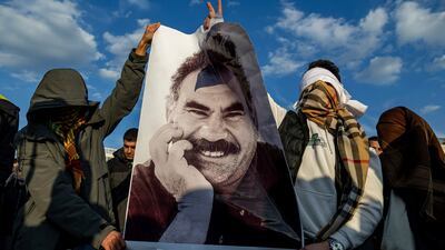 Demonstrators carry a photograph of Abdullah Ocalan, the jailed leader of the Kurdistan Workers' Party, in Diyarbakir, Turkey. AP