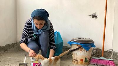 Razan Alnajar prepares milk for the kittens. Nagham Mohanna for The National