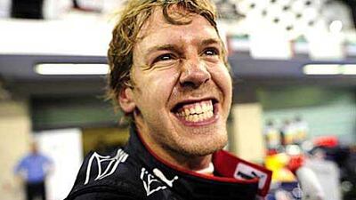 Red Bull's German driver Sebastian Vettel celebrates in the park ferme.