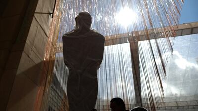 Workers wheel an Oscars statue. Reuters