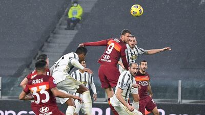 Roma striker Edin Dzeko wins a header. EPA