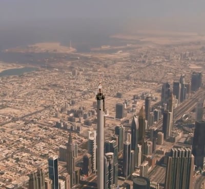 When the drone camera zooms out, skydiver and stuntwoman Nicole Smith-Ludvik can be seen standing at the top of the Burj Khalifa. Emirates