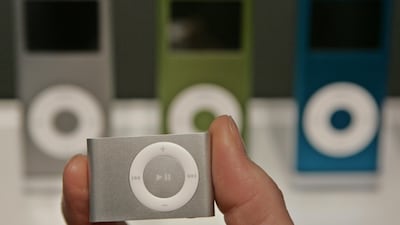 File - A new Apple iPod Shuffle is shown in front of new iPod Nanos during announcement at an Apple event in San Francisco, Tuesday, Sept. 12, 2006. Jobs also announced a new iPod nano with a 24-hour battery life and new games for the portable media play???