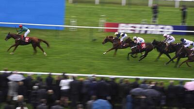 Silvestre De Sousa riding Scatter Dice, left, well ahead of the Betfred Cesarewitch field at Newmarket racecourse on Saturday. Alan Crowhurst / Getty Images
