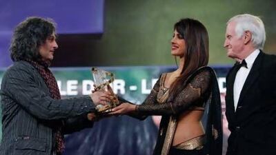Bollywood actress Priyanka Chopra, centre, gives Lebanese director Ziad Doueiri, left, The Golden Star award, the festival's grand prize, for his film ‘The Attack’ as jury president John Boorman watches during the 12th Marrakech International Film Festival.