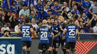 Inter Milan players celebrate with Stevan Jovetic after his opening goal against Chelsea. Roslan Rahman / AFP