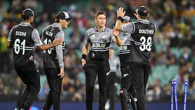 Trent Boult celebrates with teammates after bowling Australia's Mitchell Starc. AFP