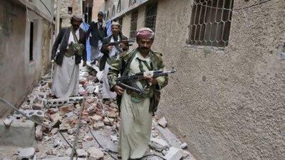 Tribesmen check the damage around the house of Sheikh Sadeq al Ahmar, the head of the powerful Hashed tribe, caused by clashes with Yemeni security forces in Sana'a in May. Hani Mohammed / AP Photo