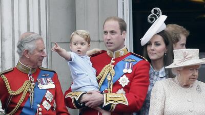 Britain’s Prince William holds his son Prince George, with Queen Elizabeth II, right, Kate, Duchess of Cambridge and the Prince of Wales during the Trooping The Colour parade at Buckingham Palace, in London. Tim Ireland / AP photo