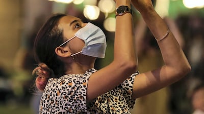A woman watches as Global Village attempts to break its 25th Guinness World Record of the season. Chris Whiteoak / The National