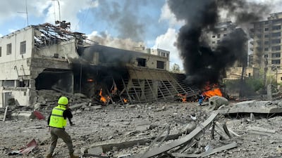 First responders rush to the site of an Israeli air strike that targeted the Lebanese State Security office in the southern town of Nabatieh on Friday. AFP
