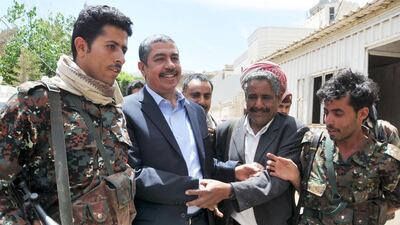 Yemeni prime minister Khaled Bahah (second from left) is greeted by supporters outside his house in Sanaa on March 16, 2015 after the Houthis agreed to free him and all his cabinet ministers after nearly two months of house arrest. STR/AFP Photo